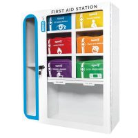 A large white metal cabinet with a clear window. Inside, it holds multiple color-coded modules (blue, red, orange, purple, etc.) organized by injury type for quick response in high-traffic workplaces.