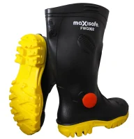 Image of black rubber boots featuring a bright yellow outsole. The boots have a round orange tag on the side, suggesting they are designed for safety and outdoor use.