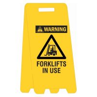 A yellow caution sign shaped like an A-frame displaying a warning symbol, featuring a graphic of a forklift and the text "WARNING FORKLIFTS IN USE."