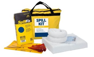 A yellow zippered carry bag labeled "Spill Kit" displayed with white absorbent booms, a stack of white absorbent pads, and red hazardous waste disposal bags