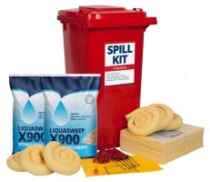 A spill kit housed in a red bin, shown with two bags of "X900" absorbent, stacked yellow pads, and rolled absorbent socks.