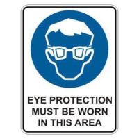 A rectangular sign featuring a blue background with a simplified illustration of a face wearing glasses, accompanied by the text "EYE PROTECTION MUST BE WORN IN THIS AREA".