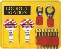 Yellow wall-mounted "LOCKOUT STATION" board holding several red padlocks, metal hasps, and "DO NOT OPERATE" safety tags.