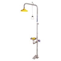 Stainless steel emergency shower and eyewash station featuring a foot pedal, yellow shower head, and yellow dust covers for the eyewash bowls.